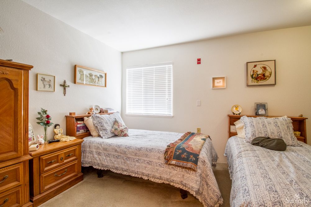 A cozy bedroom with twin beds and warm decor.