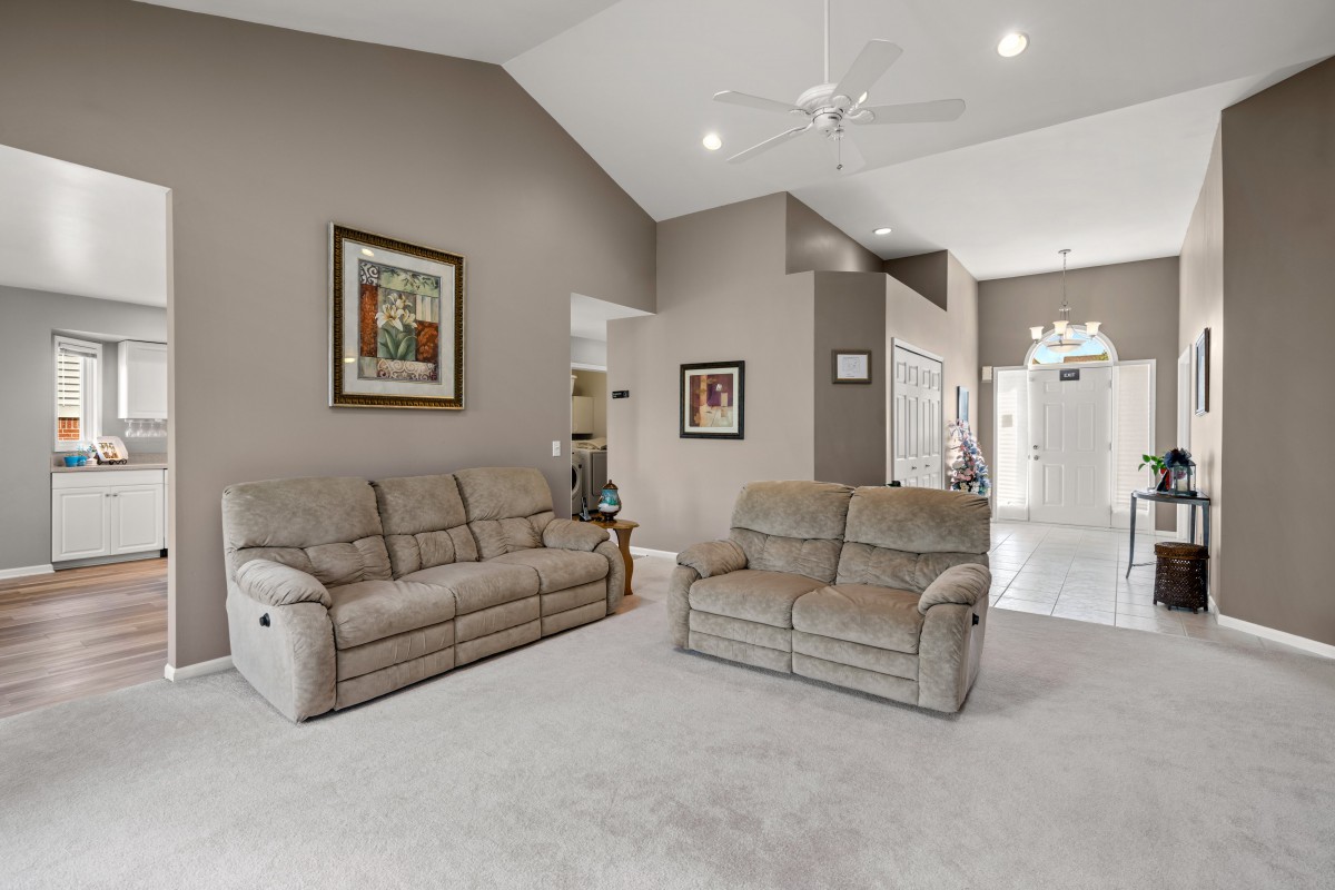 A cozy living room with sofas and artwork on the walls.