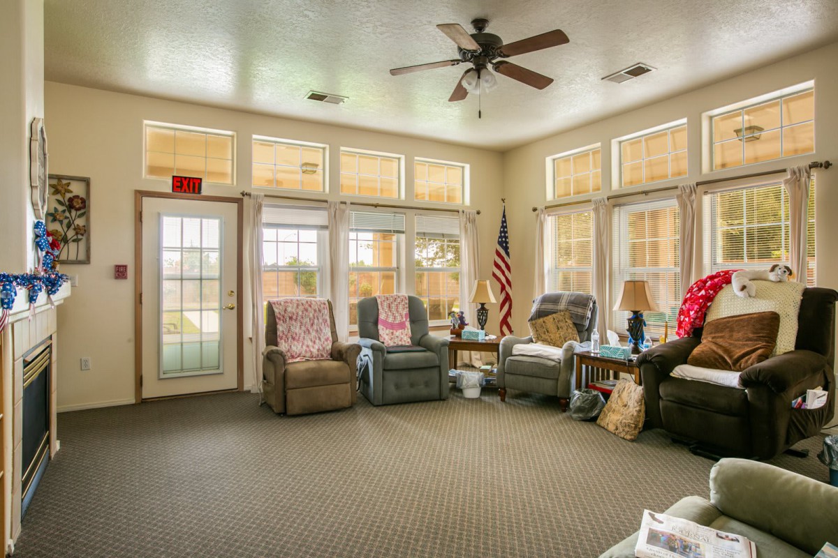 A cozy living room with comfortable recliner chairs and large windows allowing natural light.