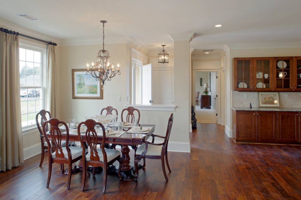 A classic dining room with elegant furnishings and a chandelier.