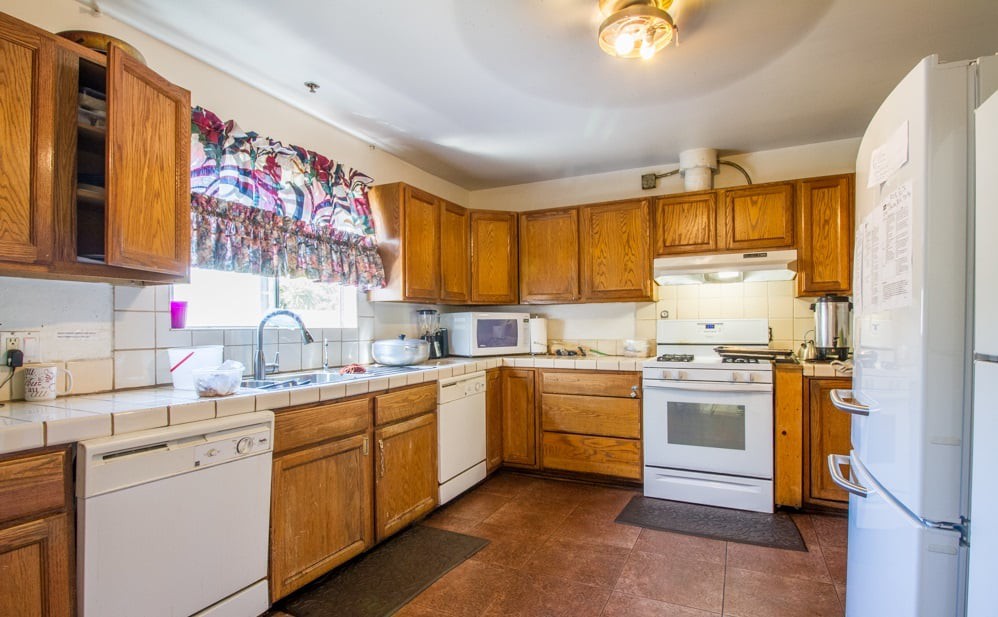 A cozy kitchen with wooden cabinets and modern appliances.