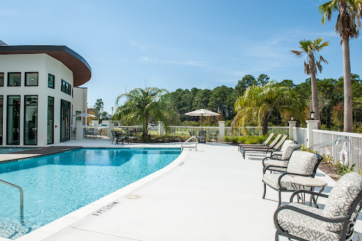 A serene outdoor pool area featuring comfortable lounge chairs and a sunny atmosphere.