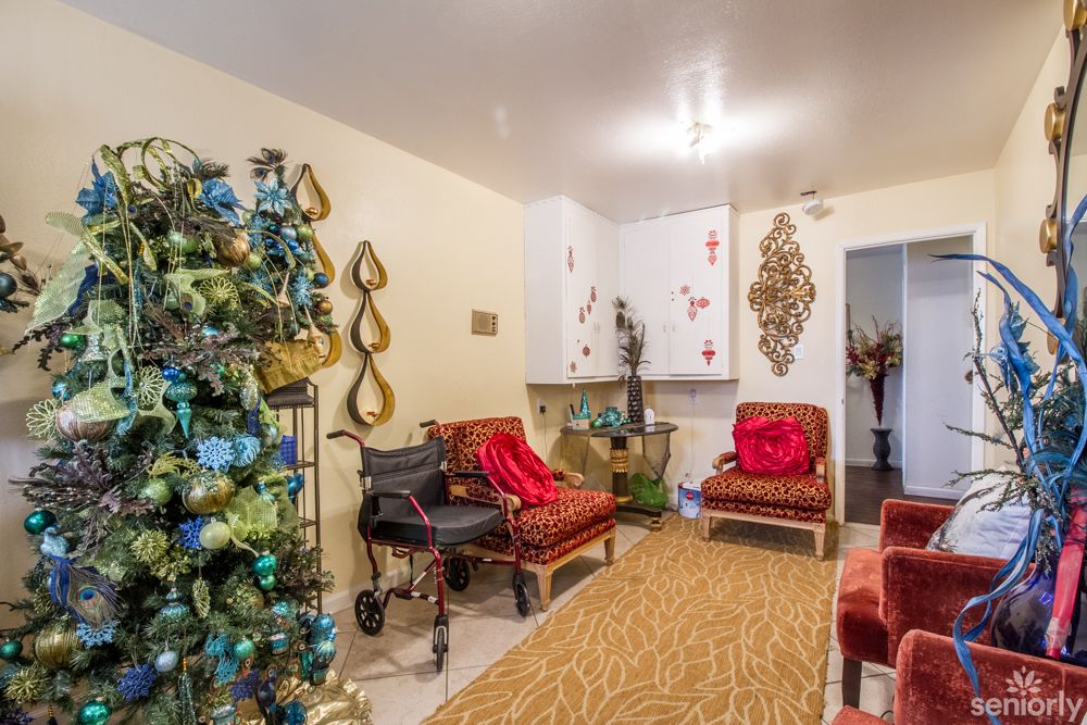 A cozy living room adorned with a Christmas tree and festive decorations.