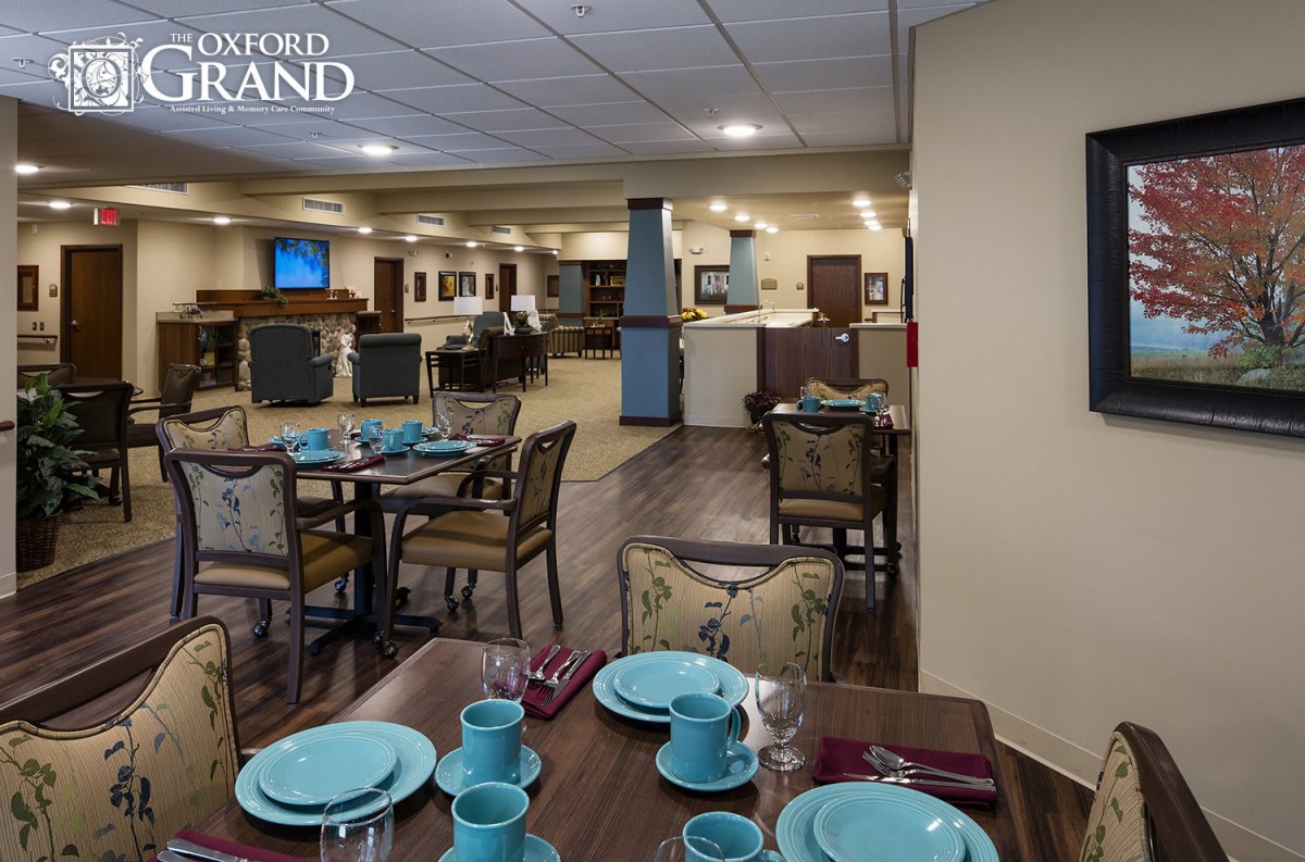 A cozy dining room setup with tables and chairs, elegantly arranged with blue tableware, creating a welcoming restaurant ambiance.