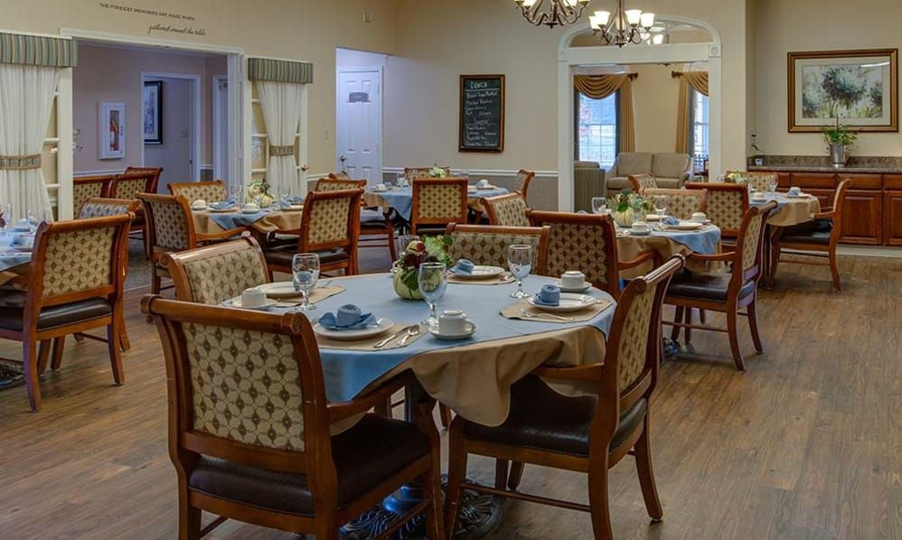 A cozy dining room with elegantly set tables and comfortable chairs.