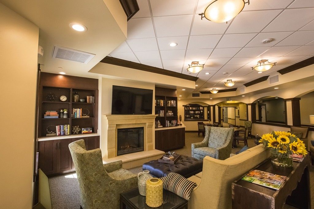 A cozy living room with comfortable seating, a fireplace, and a television.