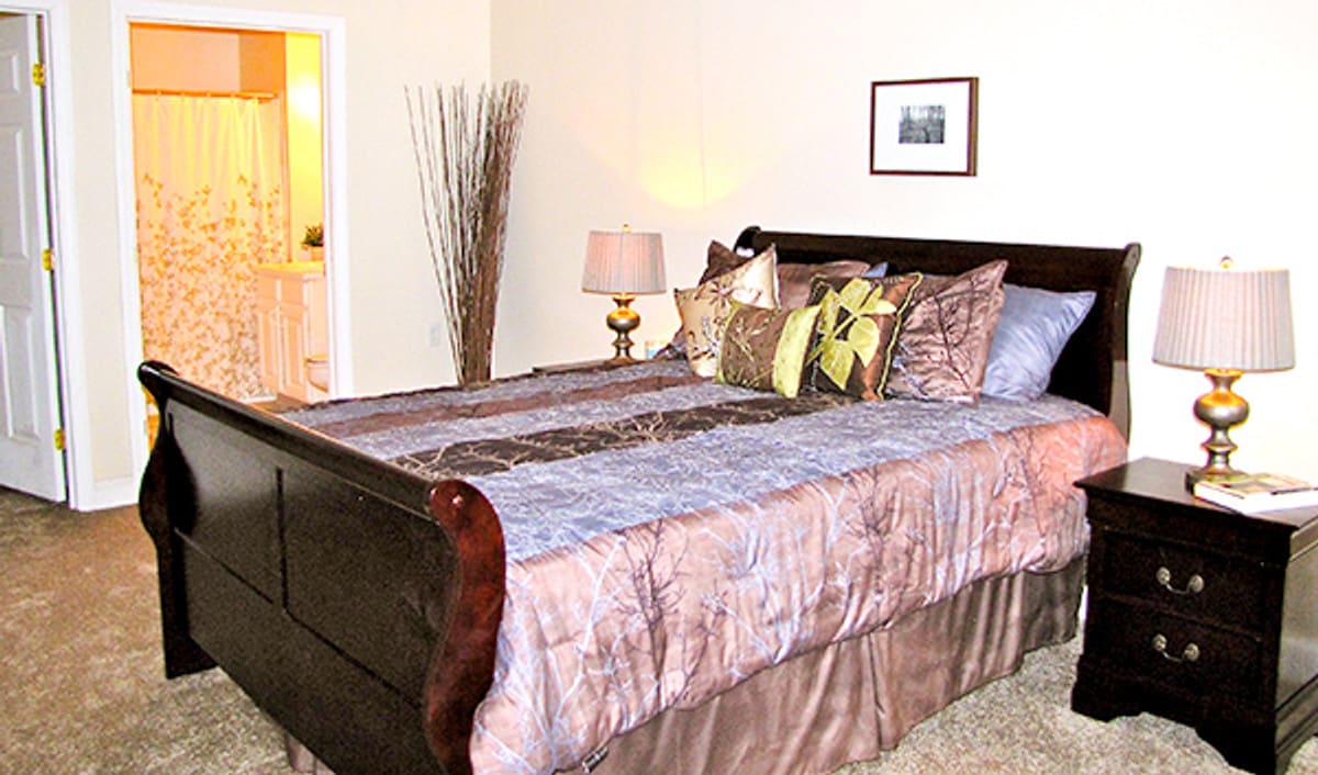 A cozy bedroom with a well-made bed and elegant decor.