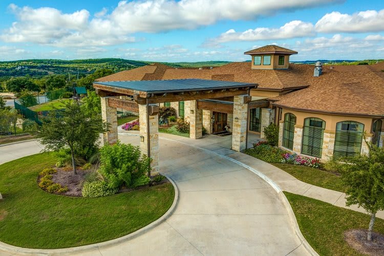 A picturesque building with a covered entrance and a scenic landscape.