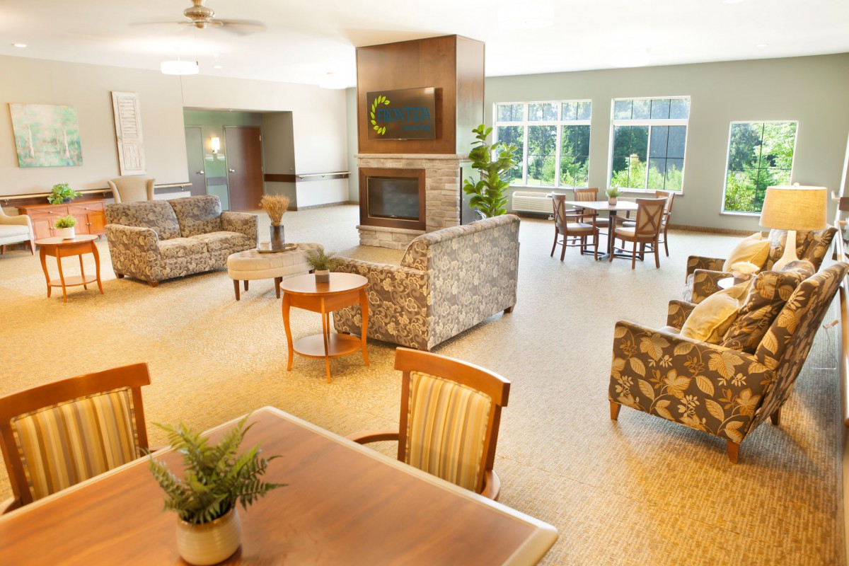 A spacious and modern lobby featuring comfortable seating areas, warm lighting, and elegant decor.