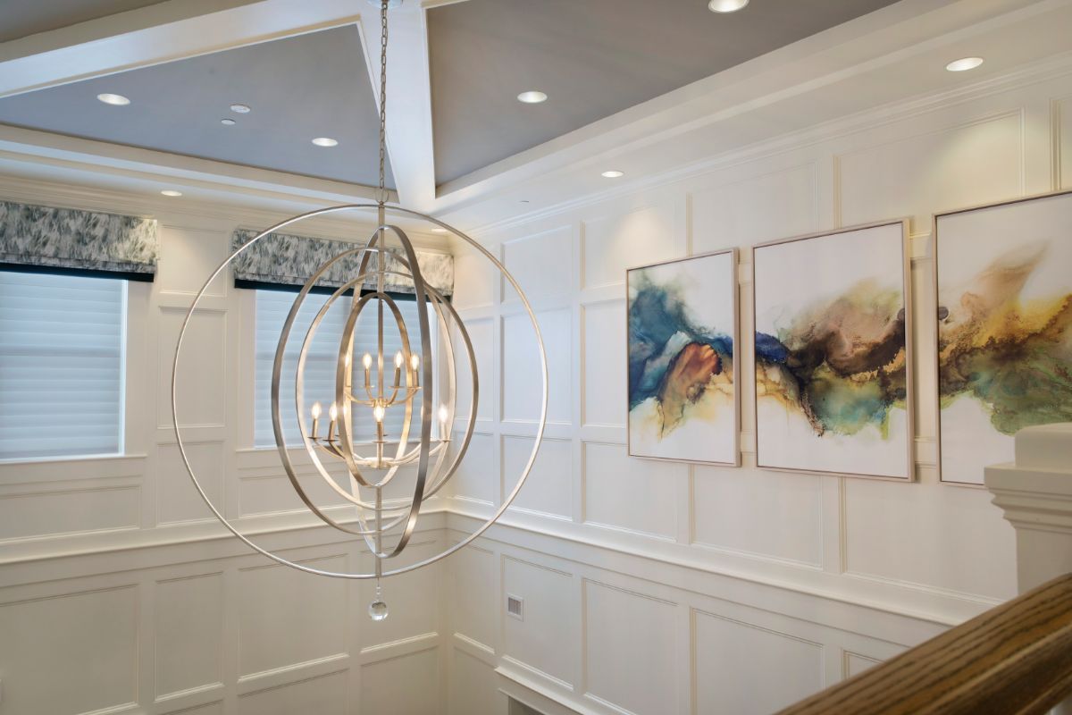 A modern interior with abstract art and stylish lighting fixtures.