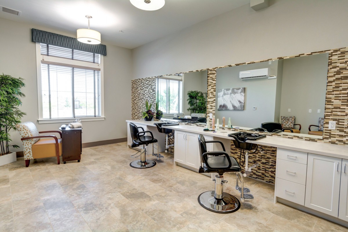 A sleek and modern hair salon interior with chairs and mirrors.