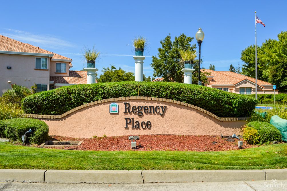 Entrance sign for Regency Place neighborhood with well-maintained landscaping.