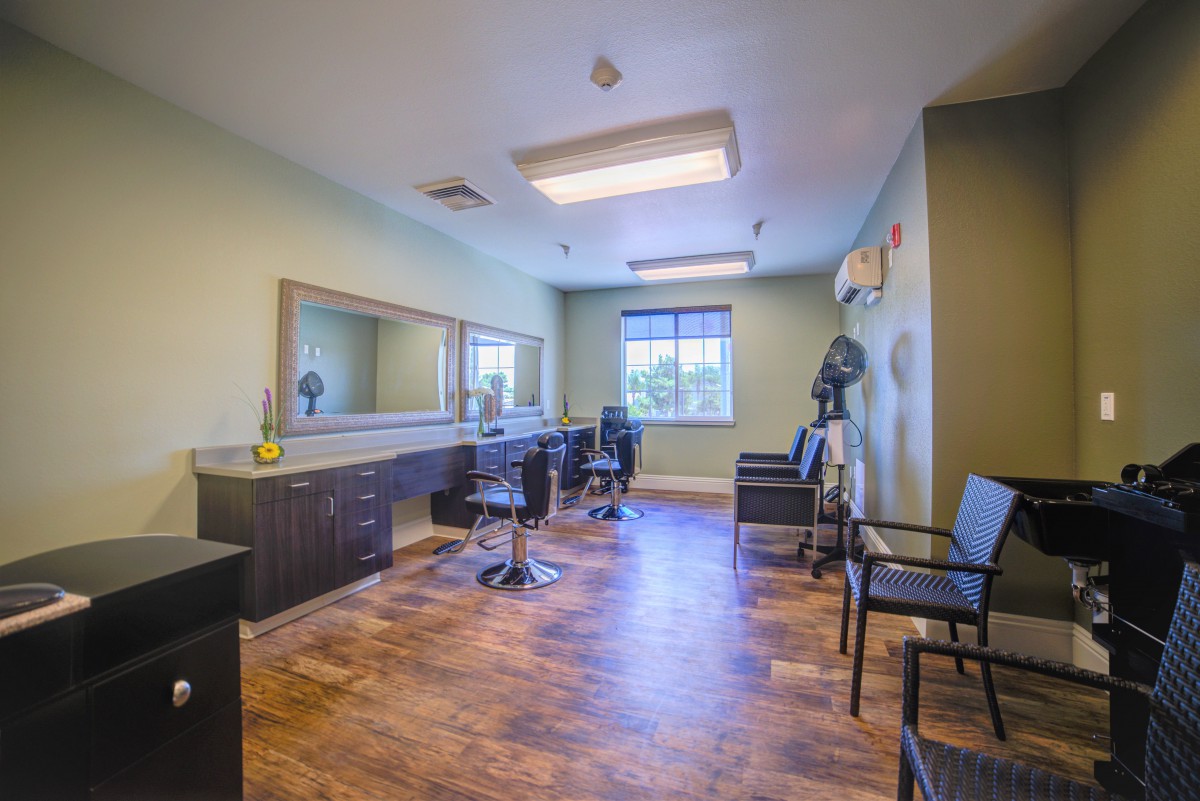 A well-lit hair salon with styling stations and chairs.