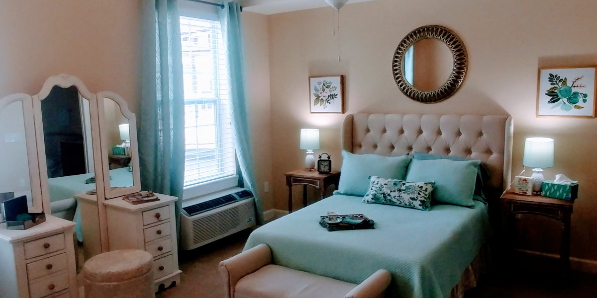 A cozy bedroom with turquoise decor and ample natural light.