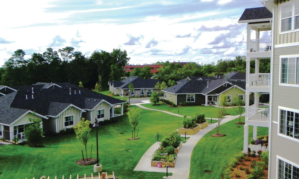 A picturesque suburban neighborhood with green lawns and winding pathways.