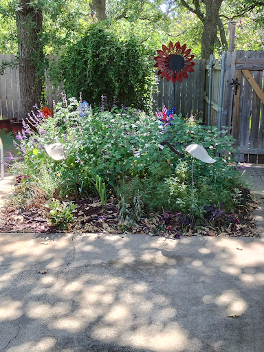 A vibrant garden filled with a variety of flowers, complemented by decorative elements.
