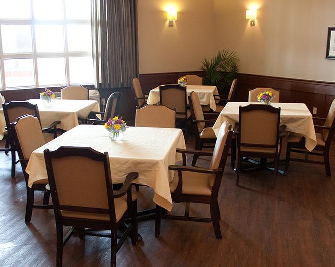 A cozy dining room with neatly set tables and chairs, ready for guests.