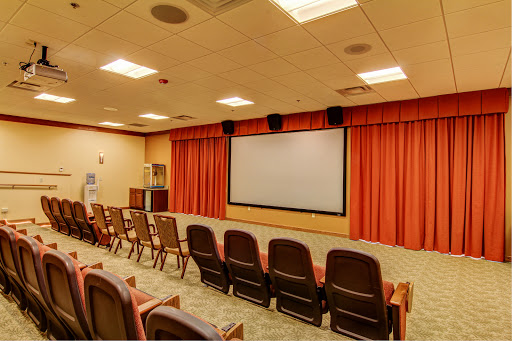 A spacious screening room equipped with comfortable seating and a large projection screen.