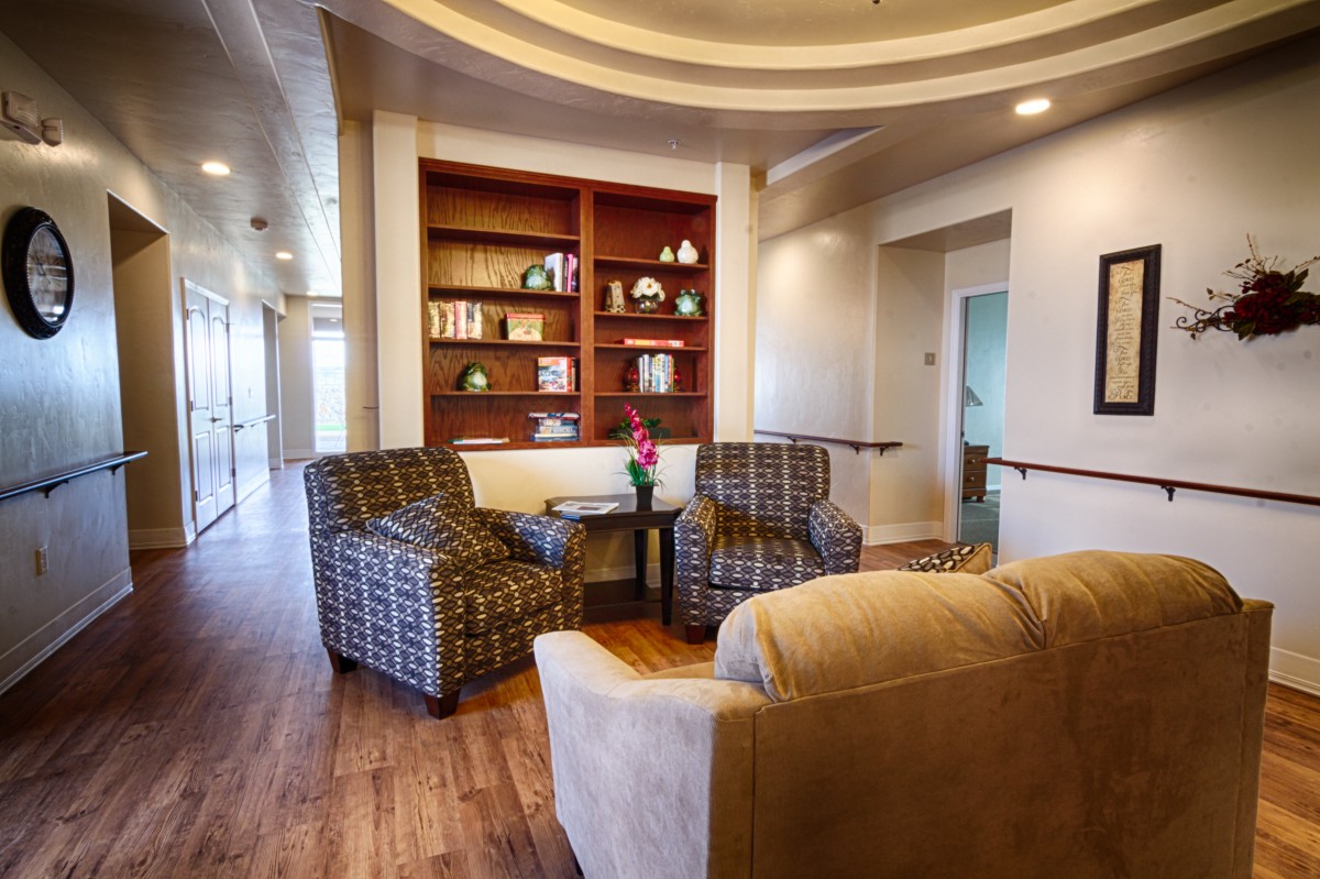 A cozy lounge with comfortable seating and a bookshelf.