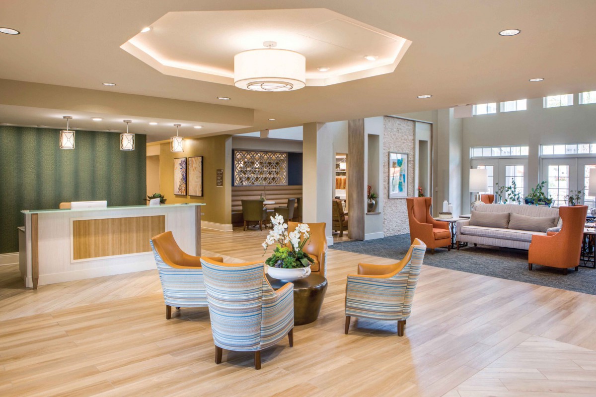 A modern lobby featuring comfortable seating and a reception desk.