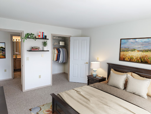 A cozy and well-decorated bedroom featuring a wooden bed frame, bedside lamp, and organized closet.
