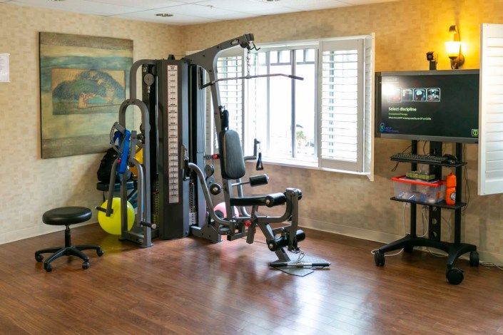 A well-equipped home gym with a multigym machine and exercise area.