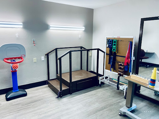 A physical therapy space equipped with a ramp for rehabilitation exercises.