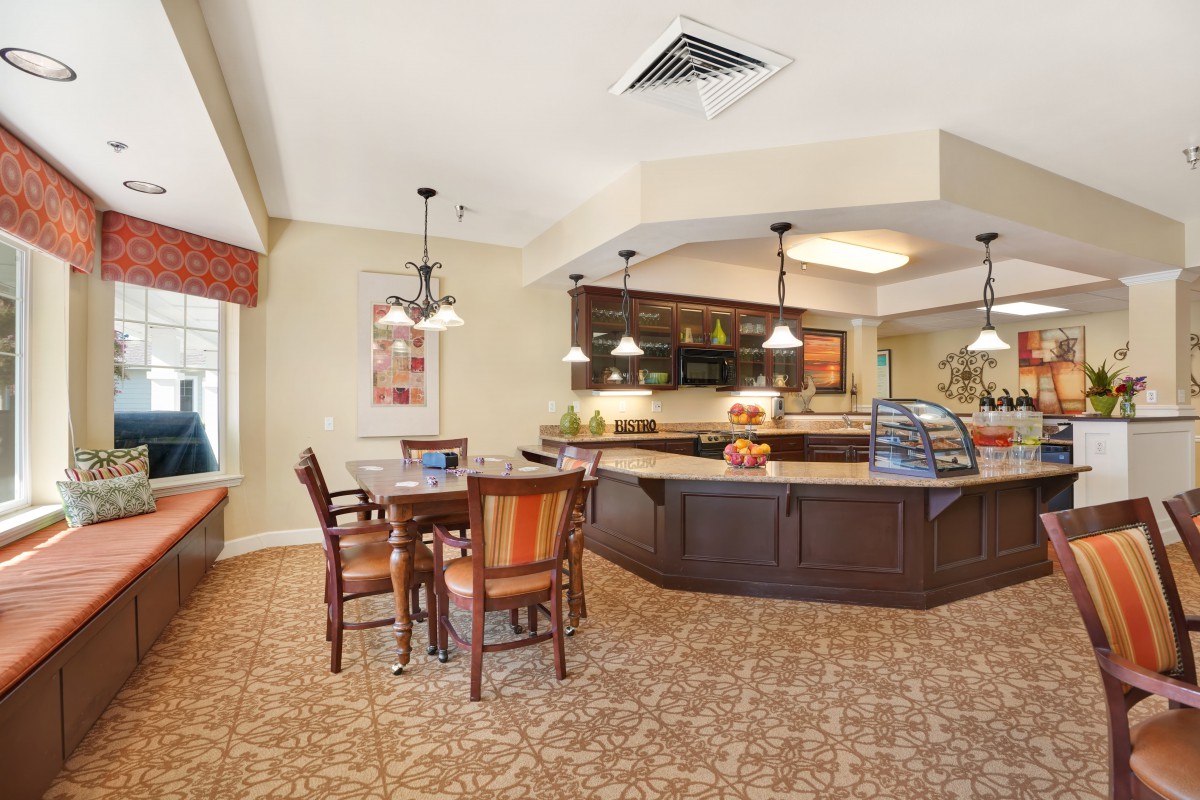 A cozy cafe interior with a seating area and a counter.