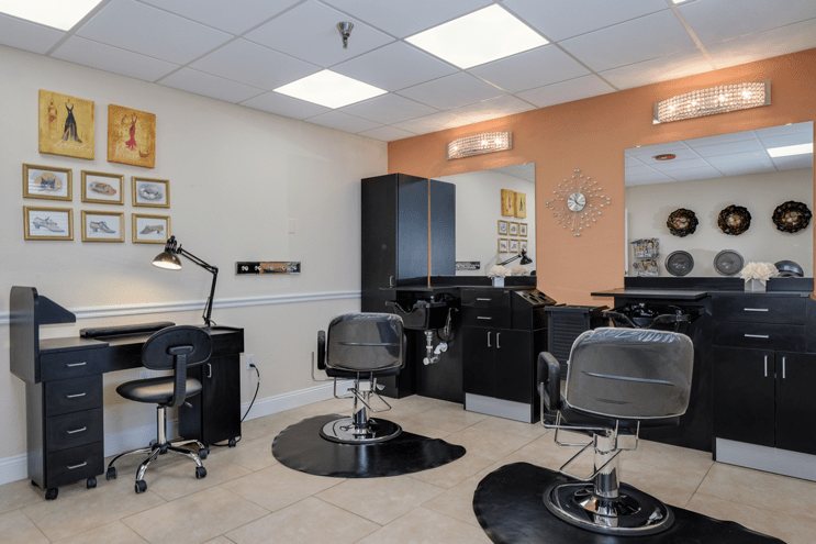 A well-lit hair salon interior with chairs and mirrors ready for clients.