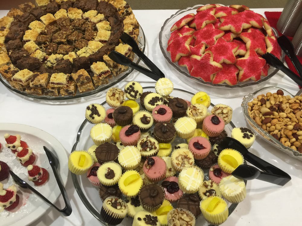 A variety of colorful desserts and pastries arranged on a buffet table.