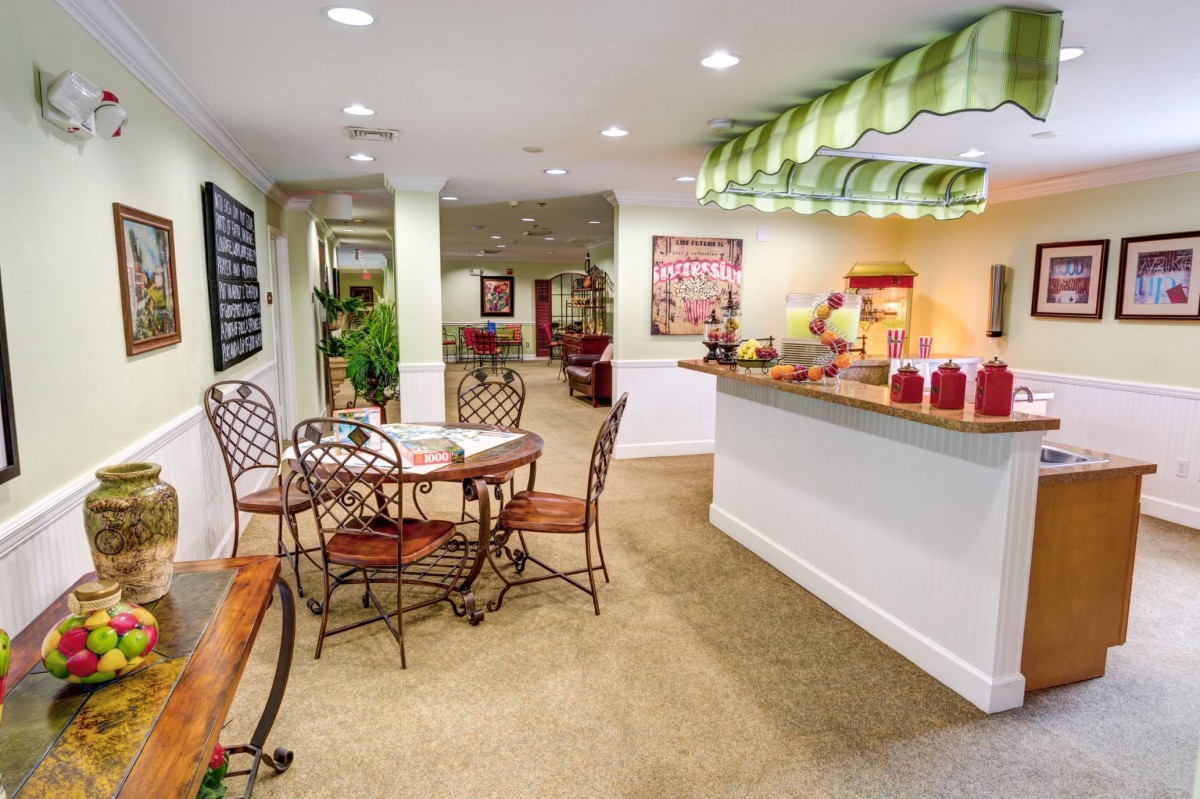 A cozy indoor cafe with a seating area and bar counter.