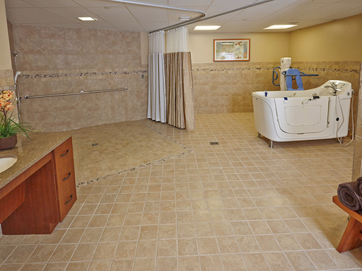 A spacious and soothing spa-like interior with tiled flooring and a bathtub.