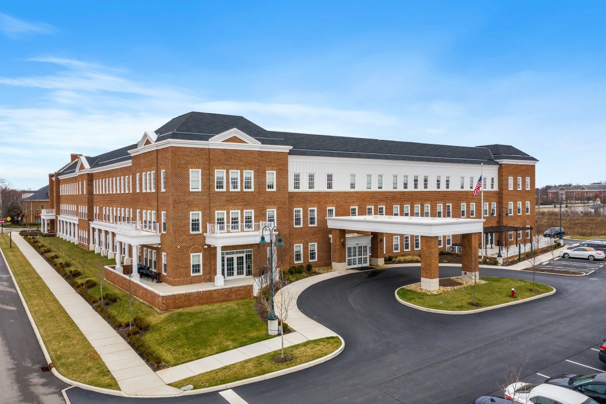 A modern healthcare facility with a prominent entrance and brick exterior.
