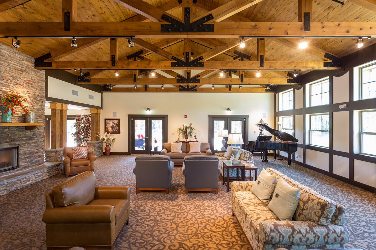 Spacious living room with comfortable seating and a grand piano.