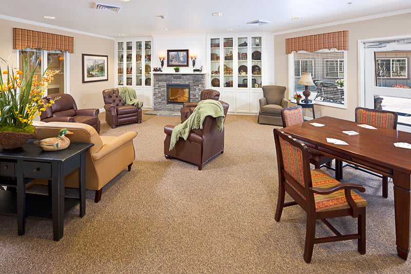 A cozy living room with comfortable seating, a fireplace, and warm decor.