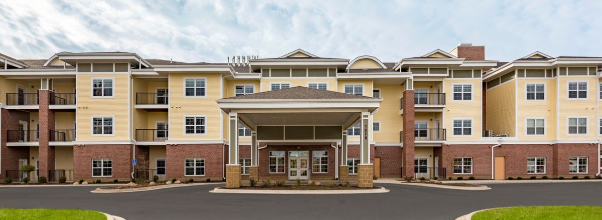 The exterior entrance of a hotel building with a covered driveway.