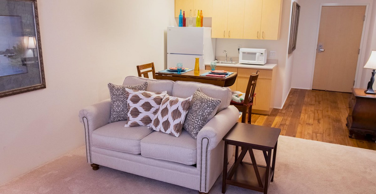 A cozy living space with a comfortable sofa and stylish kitchen area.