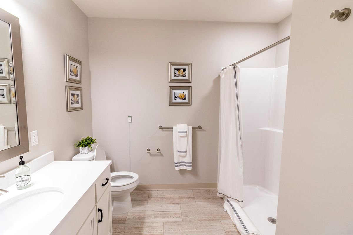 A clean, modern bathroom with a shower and minimalist decor.
