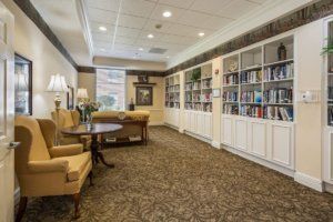 A cozy library space with bookshelves and comfortable seating.