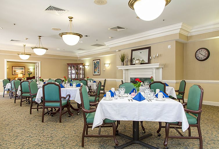 An elegant dining room with neatly set tables and ambient lighting.
