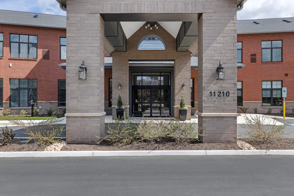 The entrance of a modern building with brick architecture.