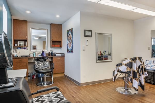 A modern hair salon interior with styling chairs and mirrors.