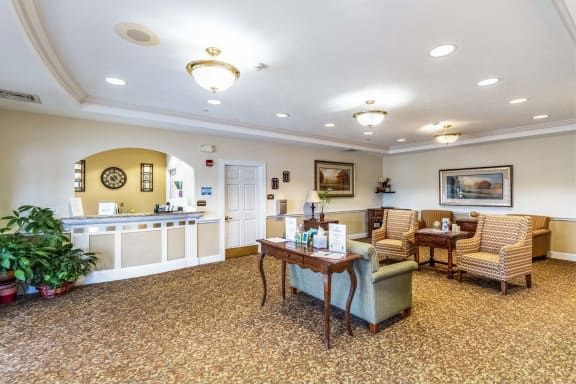 A well-lit lobby area with comfortable seating and a reception desk.