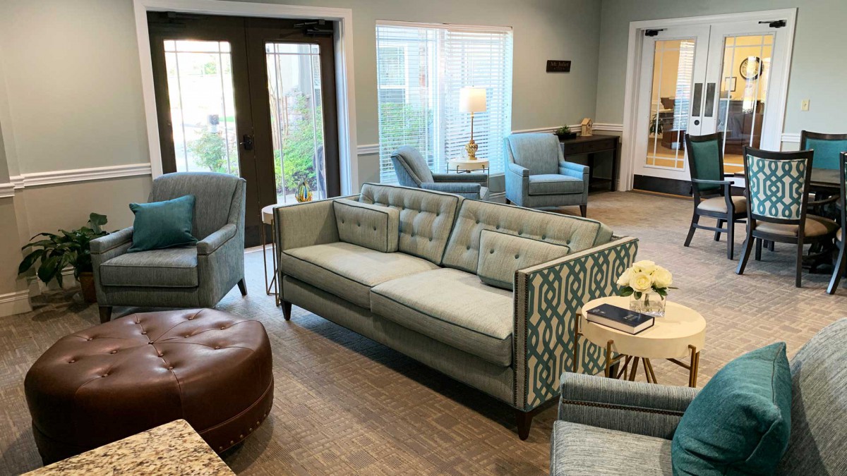 A modern living room with a stylish sofa, comfortable chairs, and elegant decor.