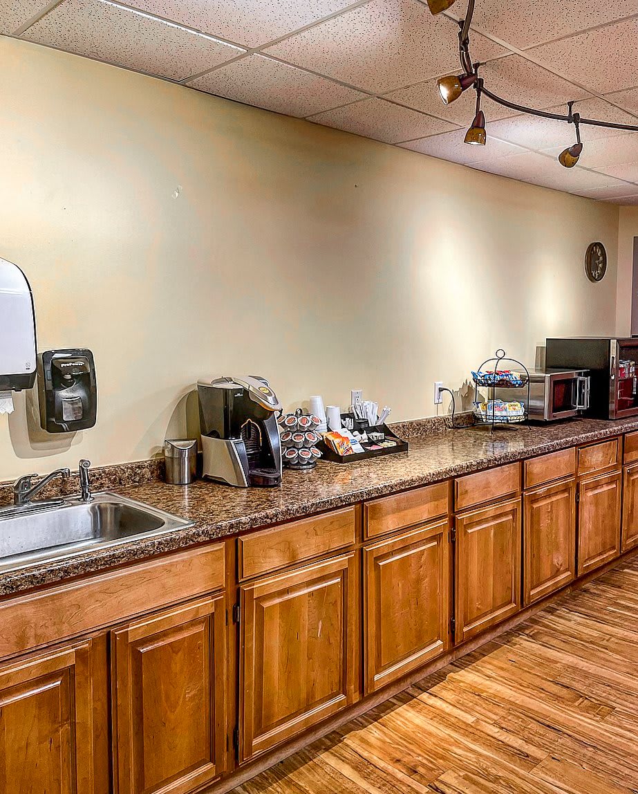 A well-equipped kitchen area with wooden cabinets and modern appliances.