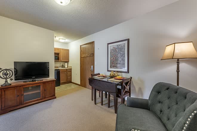 Cozy living space with a small kitchen, dining area, and comfortable seating.