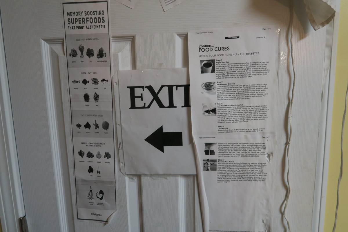 A door displaying an exit sign with instructions and notices posted around it.