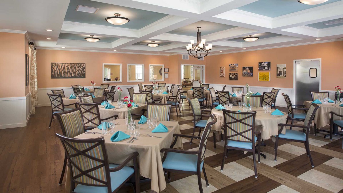 An elegant dining room with tables neatly set for guests.