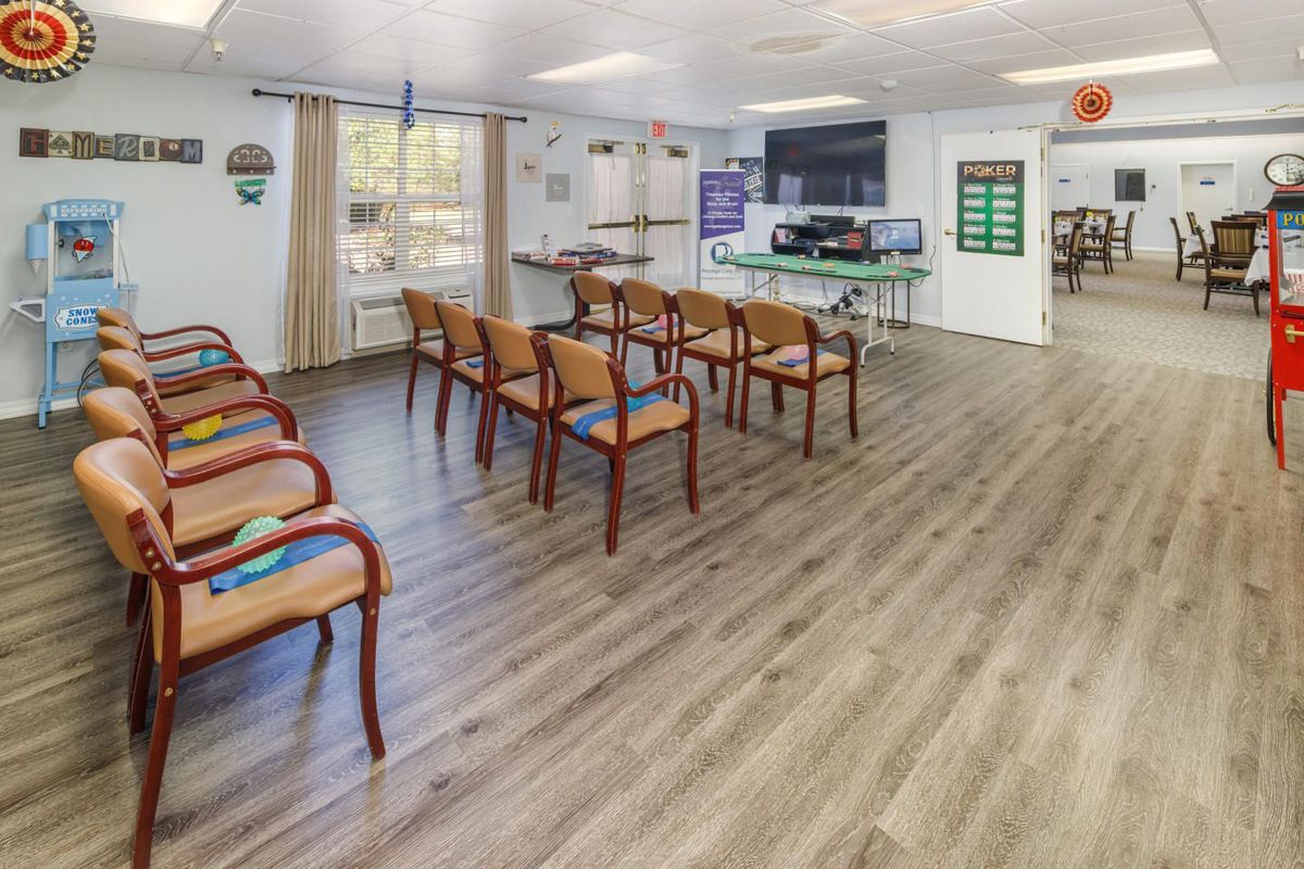 A modern waiting area with neatly arranged chairs and a television on the wall.