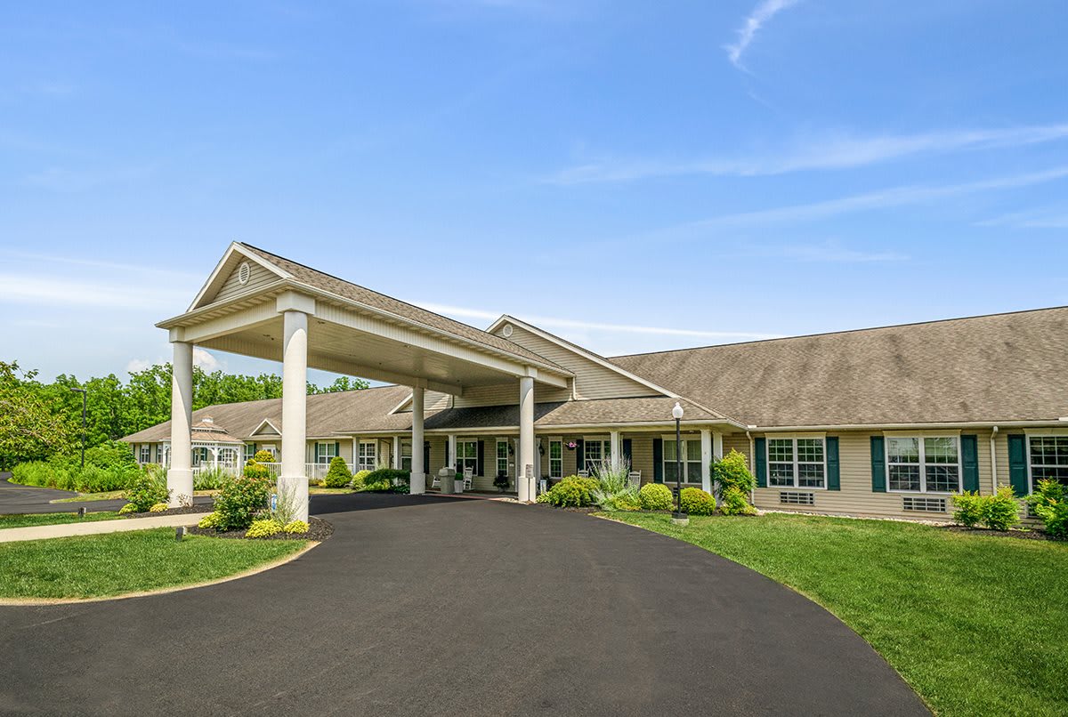 A large building with a covered entrance and driveway.